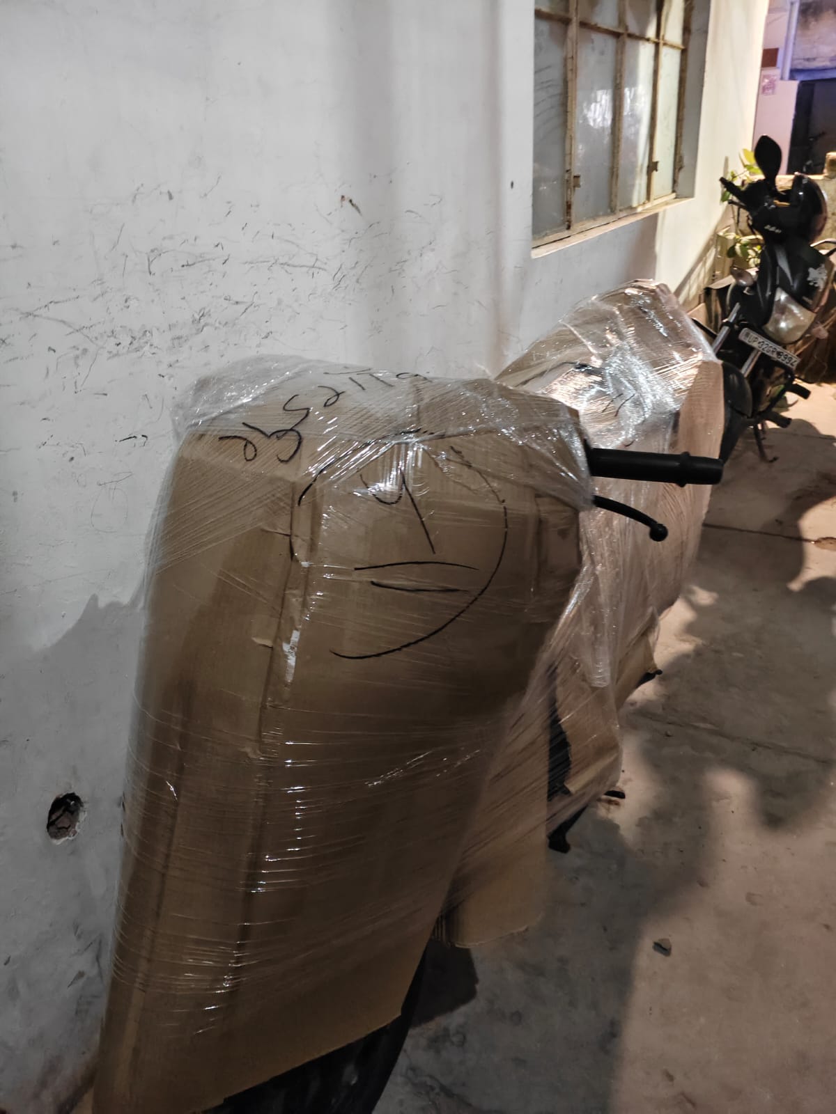 Bike packed securely in corrugated sheet and stretch wrap