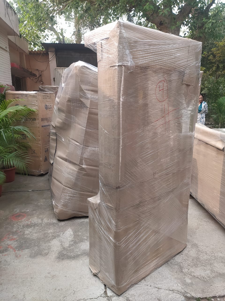 Tall almirah packed entirely in cardboard wrapping