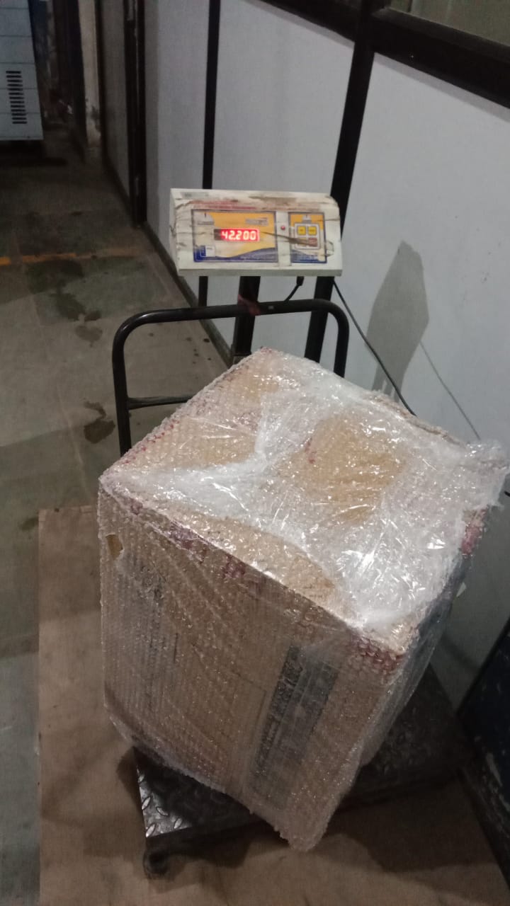Packed box on a commercial weighing scale for part load transport