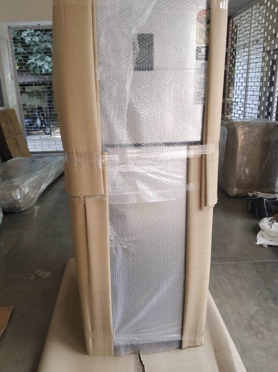 Double door refrigerator packed with corrugated sheet and bubble wrap